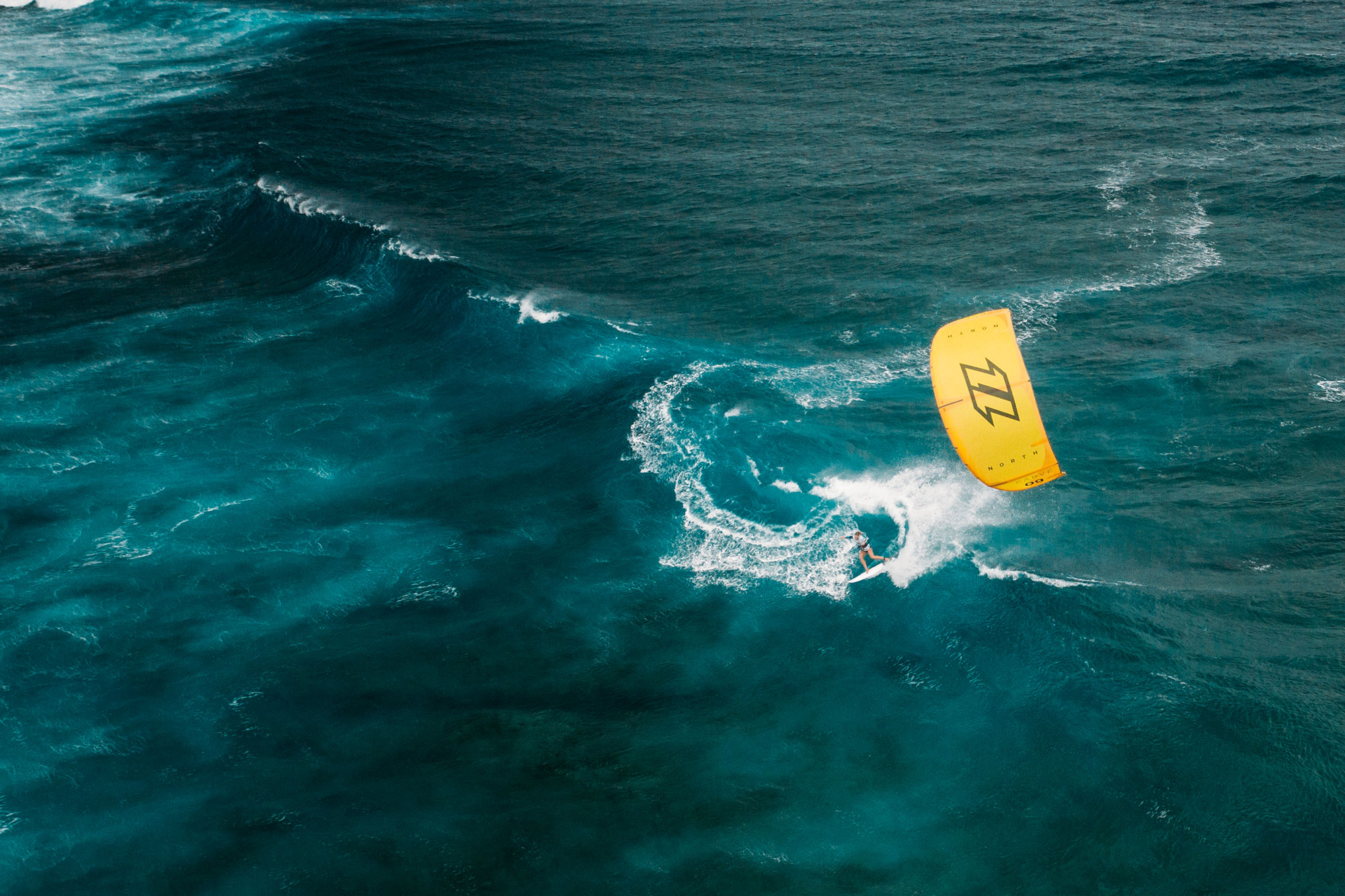 Jalou Langeree surft in der Welle vor Mauritius in einer Drohnenaufnahme aus der Luft betrachtet